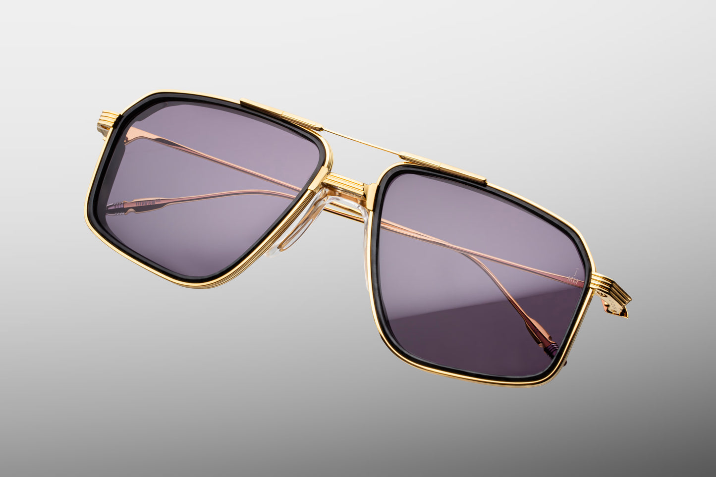  Top-down view of the JMM Jagger Ebony frame, revealing the wide square aviator geometry, structured titanium brow bar, custom clear nose pads, and robust monoblock hinge construction.