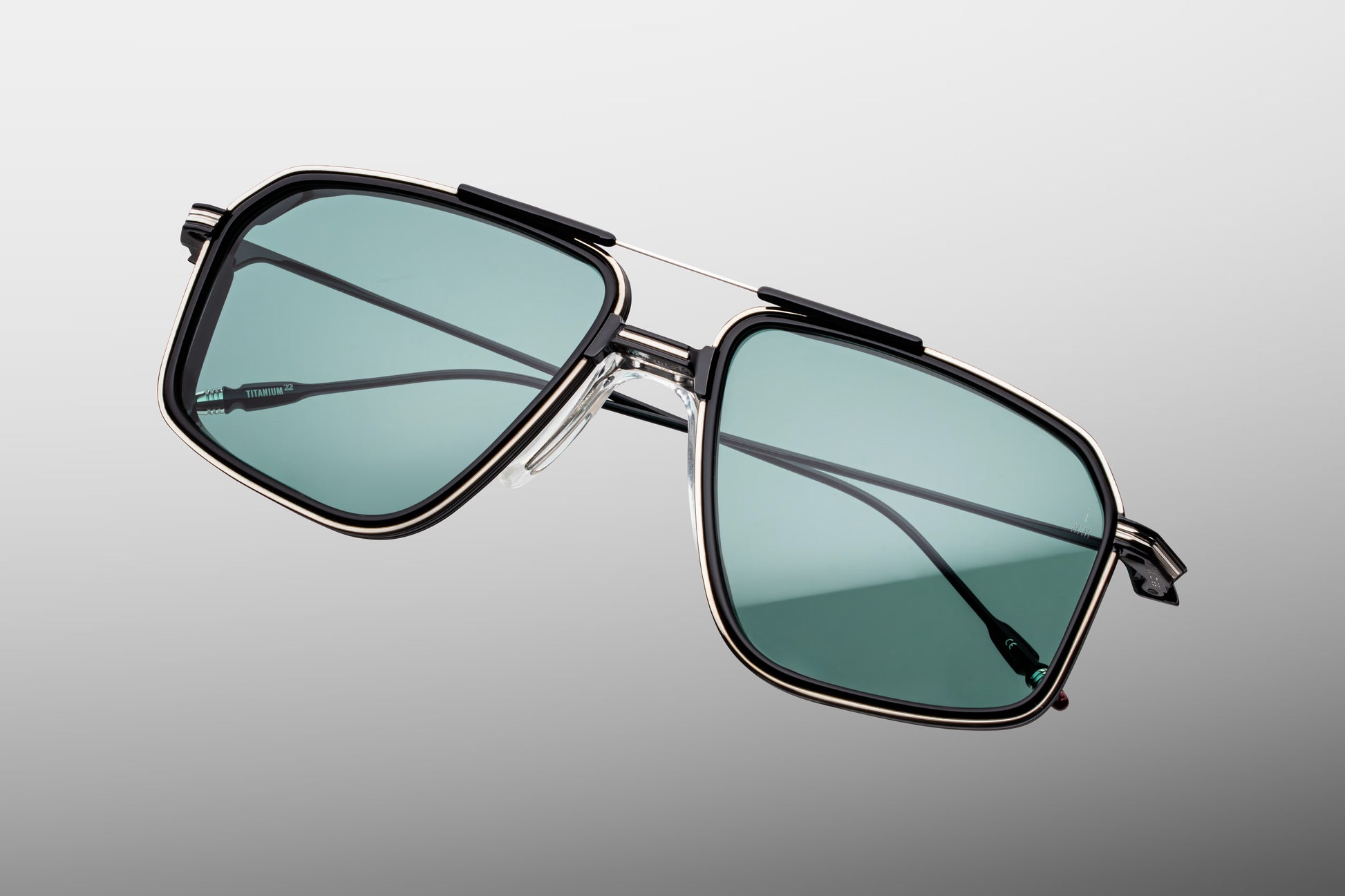 Top-down view of the JMM Jagger Paon frame, revealing the wide square aviator geometry, black titanium brow line, structural nose pads, and robust monoblock hinge build.