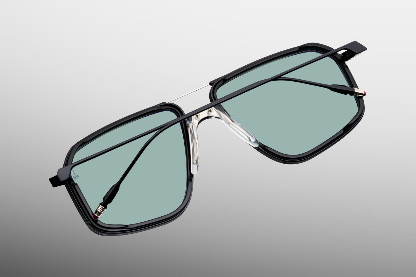 Rear perspective of the JMM Jagger Paon temples, displaying the slim black metal arms tapering into tailfin-shaped silver palladium temple tips finished with hand-painted burgundy epoxy accents.