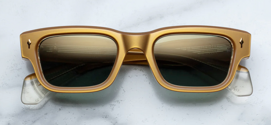 Front view of Jacques Marie Mage Jeff sunglasses in Gold, featuring a luxurious, oversized round frame in polished gold-tone metal. The frame’s bold, sculptural design is complemented by intricate detailing on the bridge and temples, offering a vintage-inspired yet contemporary look. The light, tinted lenses enhance the sophisticated, refined aesthetic