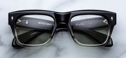 Jacques Marie Mage Cash | Black Fade sunglasses. The 10 mm thick upper half frame fades from opaque black to translucent at the bottom. Temples conceal a double-laminated acetate shell with exposed, spike tail silver wire-core and secure 9-barrel hinges. Each hinge is adorned with a sterling silver arrowhead pin. Light bottle-green CR39 lenses with backside anti-reflective coating provide full UV protection