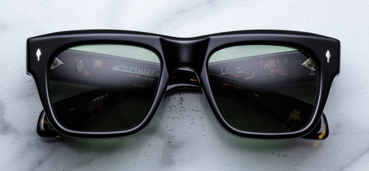 Jacques Marie Mage Cash | Noir 9 sunglasses' temple, featuring a sculptural double-laminated acetate design that conceals an exposed silver spike tail wire-core with intricate engraving. The temple is secured by a sterling silver arrowhead hinge pin and a tension-secured 9-barrel hinge, ensuring durability and a seamless aesthetic. The inner temple bears a silver “Johnny Cash” foil signature, marking this limited-edition piece. Handcrafted in Japan as part of a 500-piece run inspired by Johnny Cash's 1965 E