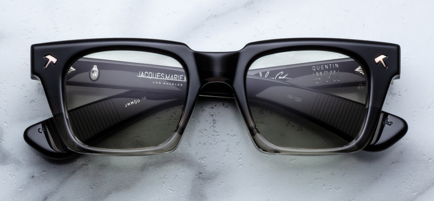Jacques Marie Mage Quentin | Black Fade sunglasses from the Johnny Cash collection. This bold, rectangular frame is crafted from 10 mm double-laminated black fade cellulose acetate featuring paddle temples. Inside the temple, a “Johnny Cash” signature foil adds a collector’s detail. Handcrafted in Japan, limited to 350 pieces and in stock at WINK Optometrists