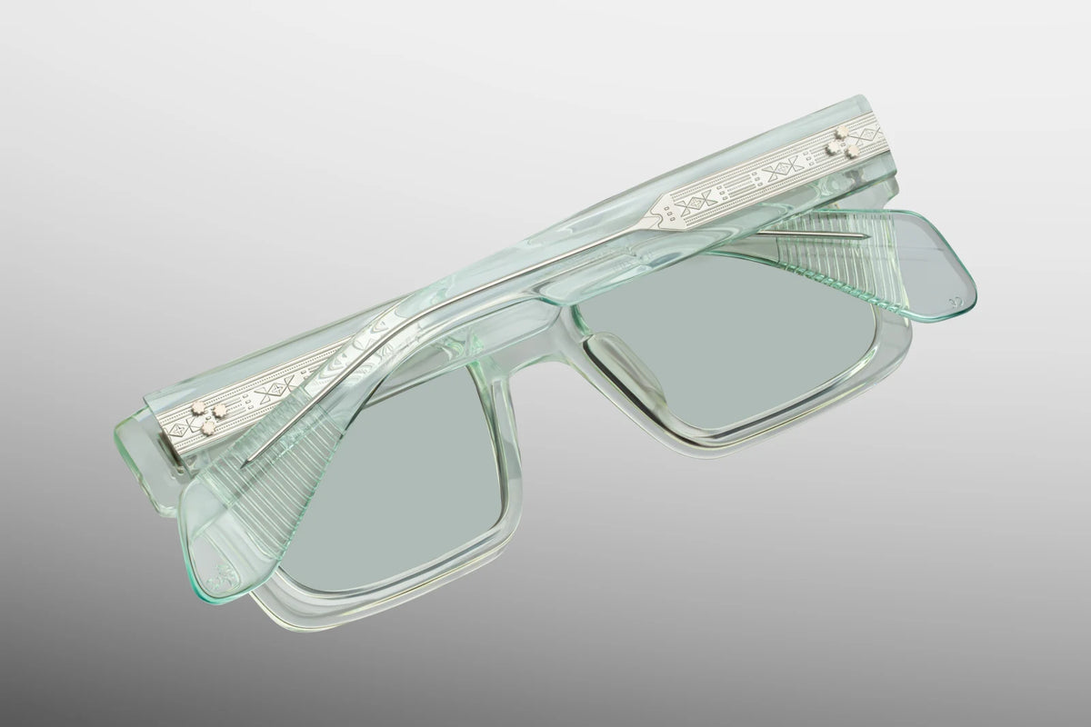 Close-up interior detail shot of the Jacques Marie Mage Kaine Aurora frame architecture. The inner view showcases the translucent light green rims against the premium sterling silver hardware. Clean silver foil-stamped text on the inner temple arm indicates the individual limited-edition serial number out of the exclusive global batch of 200 alongside the "Handcrafted in Japan" production text. Available at WINK Optometrists.
