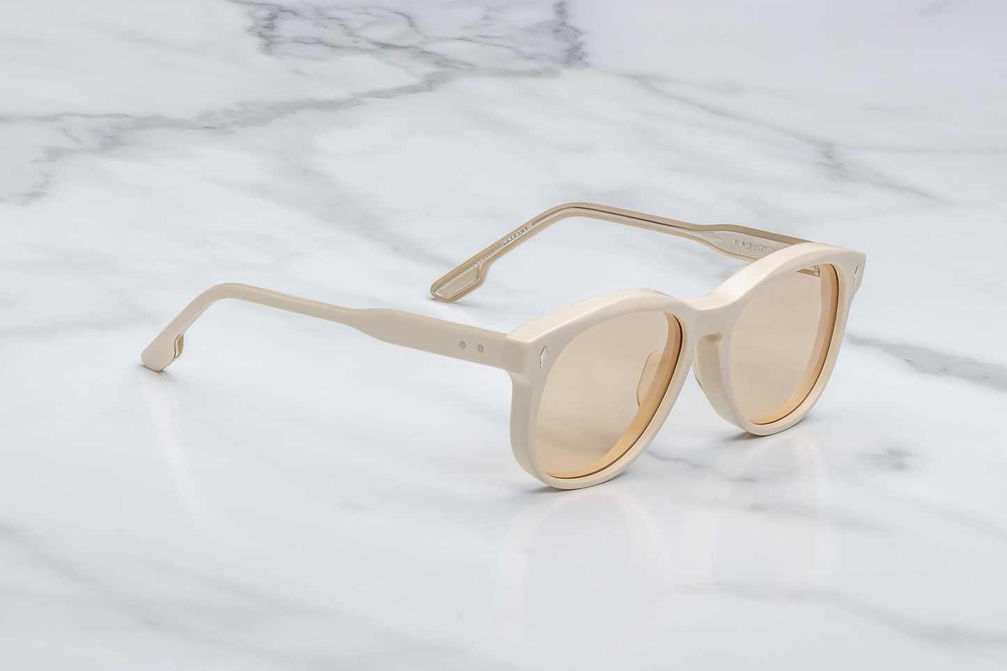 Right temple of the Kay Sun Suede — double-laminated suede acetate in matte yellow, with exposed light-gold Vauxhall wire-core and a tension-secured custom 5-barrel hinge.