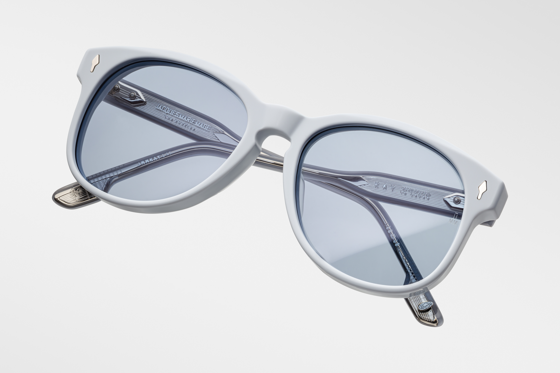 Top-down of the Kay Sky Suede — gentle arch over the bridge, softly curved frame edges, and the pale blue, slightly translucent acetate
