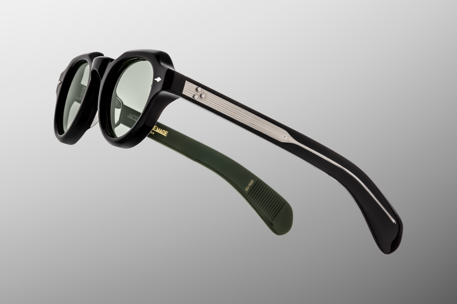 Left temple of the Kellerman Cobra — same black acetate with silver 7-barrel hinge and a domed silver JMM logo near the joint.