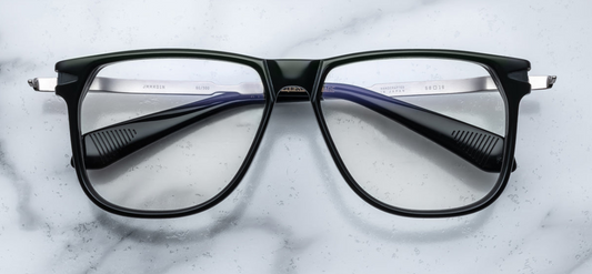 •	the 70's inspired boxy Kirkland frame by Jacques Marie mage with black cured acetate front, light green lenses and  silver 100% beta titanium temples with dark gold accents. Available at WINK Optometrists