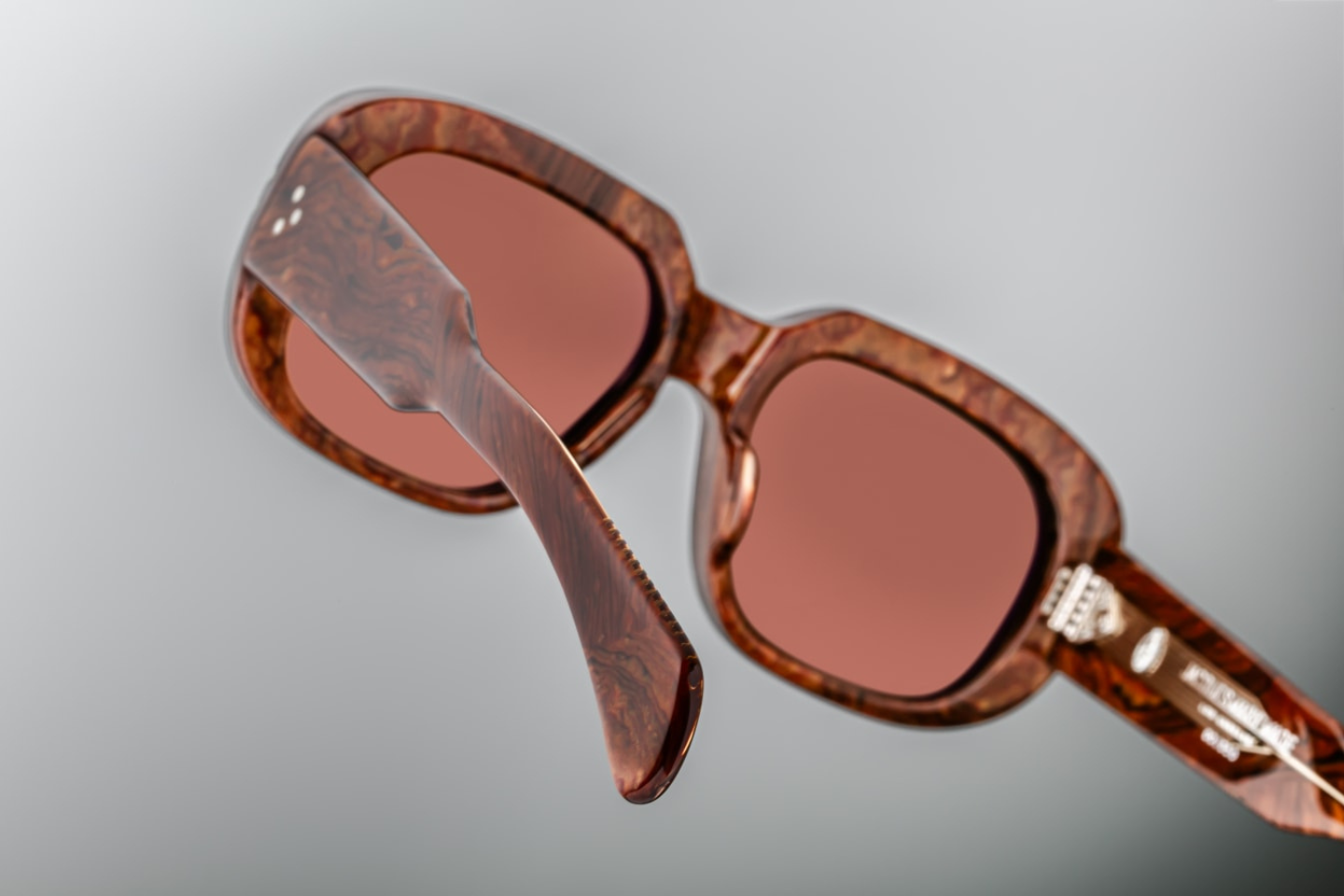 Detailed view of the temples of Jacques Marie Mage Kobo eyewear, showcasing the unique burlwood acetate pattern