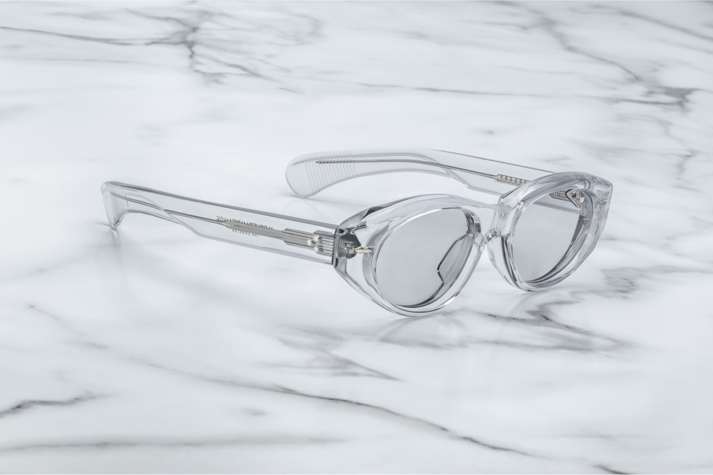 Side profile of JMM Krasner Sulfur sunglasses showing sculpted temple arms, silver arrowhead details, and premium acetate construction