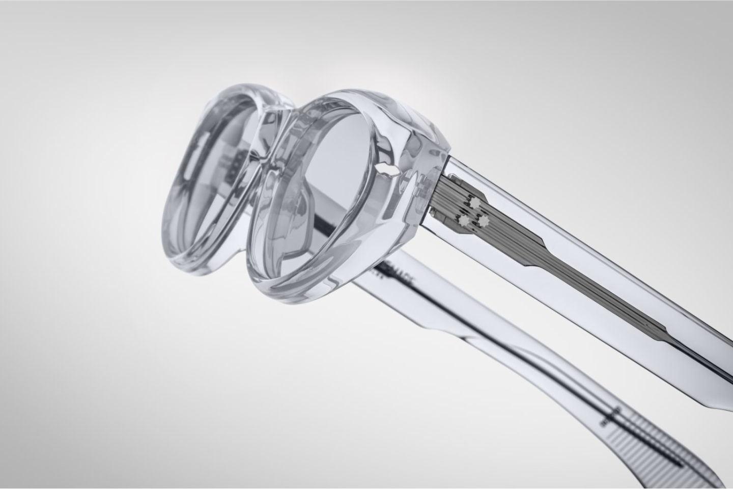 Close-up of JMM Krasner Sulfur sunglasses temple showing silver arrowhead hardware and limited-edition luxury eyewear engraving.