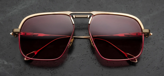 Front view of Jacques Marie Mage Labarge Champagne sunglasses. Features a large 1970s-inspired titanium navigator frame in light gold with a thick, sculptural monoblock top bar and double bridge. The eye rims are finely engraved with a Chimayo textile motif, housing mahogany gradient lenses.