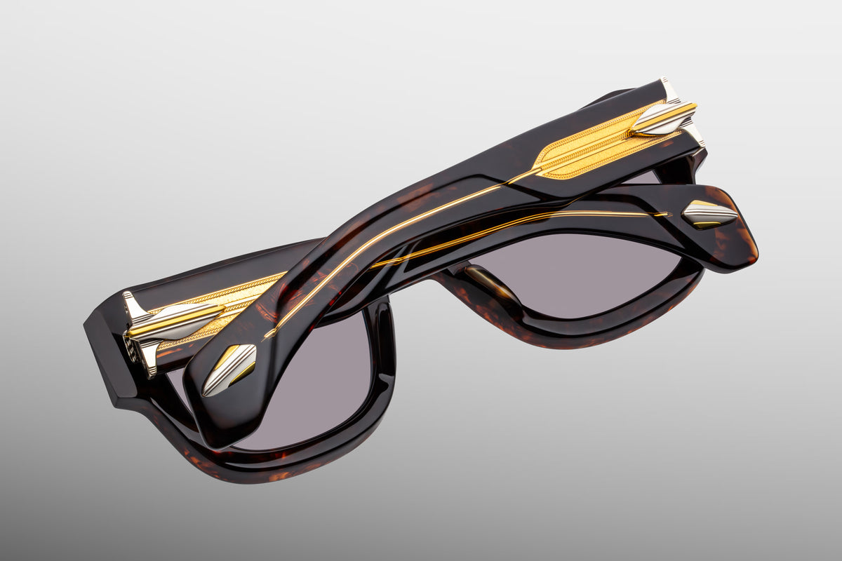 Rear view of Jacques Marie Mage Conrad Beau sunglasses with temples folded inward. The clear beige acetate temple arms fold over each other, highlighting the custom-braided dark gold wirecores from the inside. The view showcases the heavy 9-barrel hinges and the inner profile of the beveled Havana tortoiseshell acetate frame