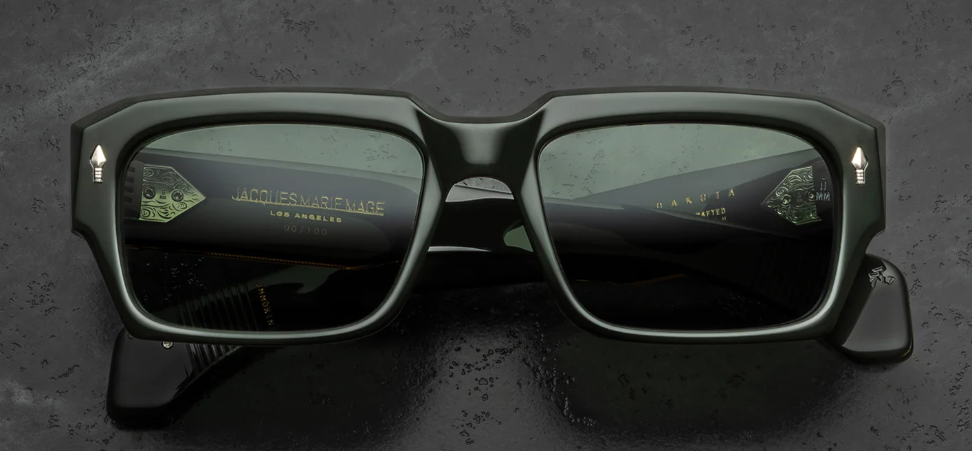 Front view of Jacques Marie Mage Dakota Viper sunglasses. Features an impressive 10mm thick, polished dark green acetate frame with a bold rectangular silhouette and aggressive bevel cuts. Signature sterling silver arrowhead pins accent the upper temples, framing solid green Tarragon mineral glass lenses