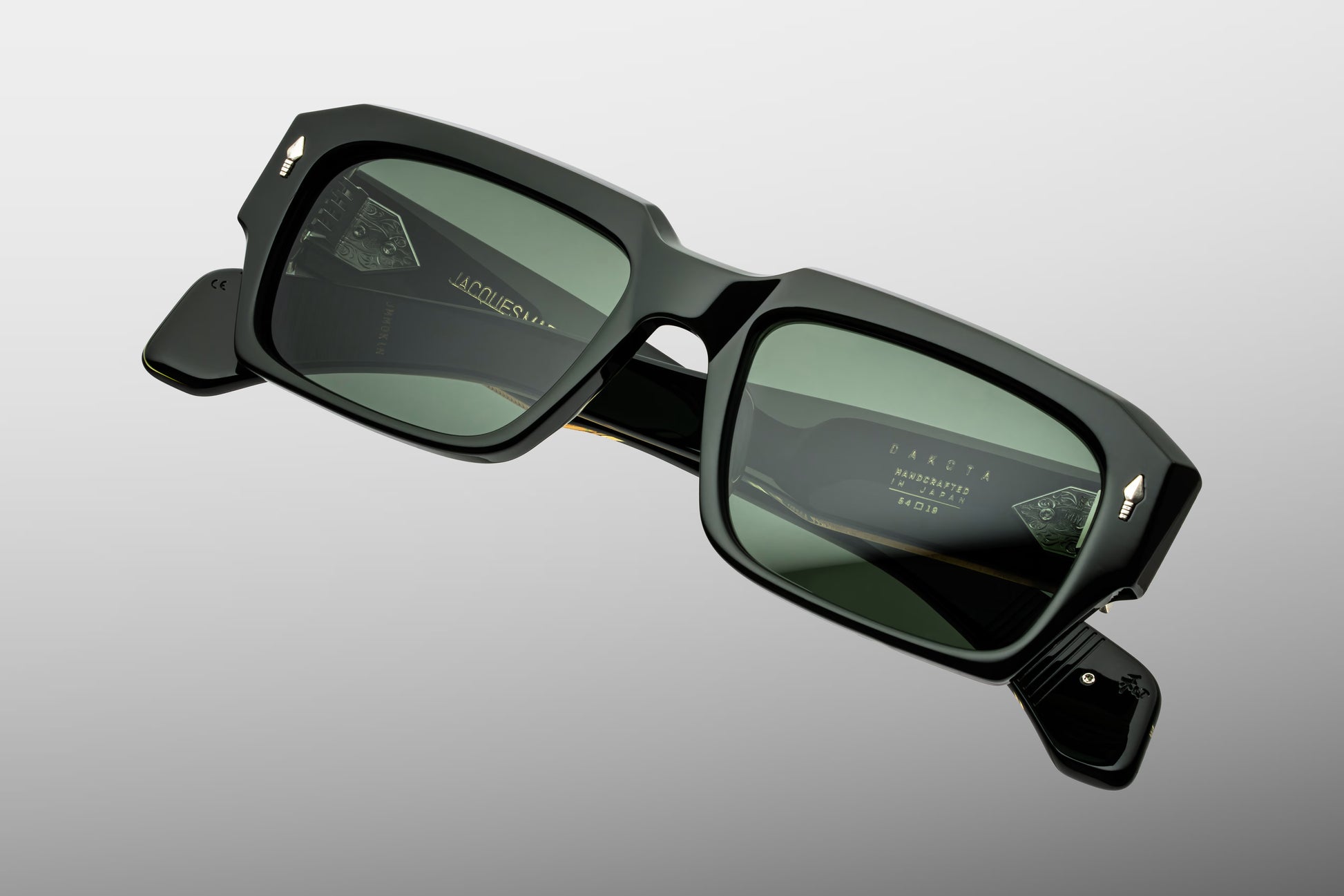 Top-down view of Jacques Marie Mage Dakota Viper sunglasses. Accents the substantial 10mm block thickness and dimensional face bevels along the top of the dark green frame. The view highlights the straight, sturdy alignment of the temples extending back