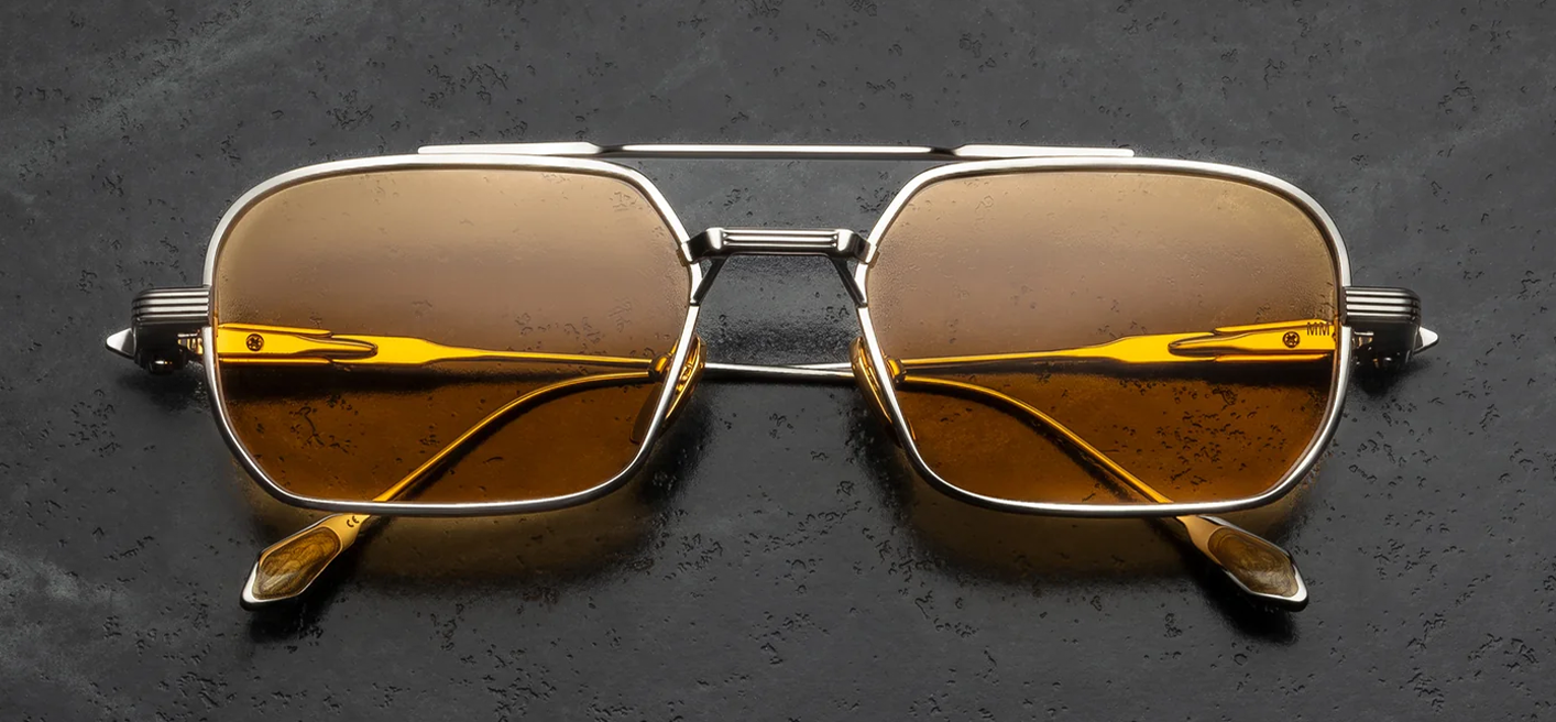 Front view of Jacques Marie Mage Deaver Electrum sunglasses. Features a medium 1990s-inspired rectangular silver palladium titanium frame with a sleek top bar and double bridge. The rectangular eye rims are finely engraved with a Chimayo textile motif and hold light yellow "Dandelion" mineral glass lenses