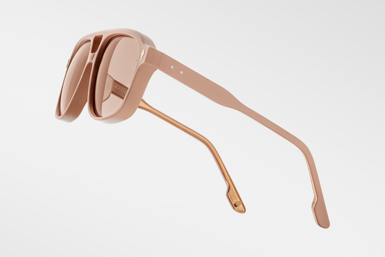 Close-up of the temple arm of Jacques Marie Mage Leonard Suede sunglasses in Dust Suede: displays the transition from the acetate frame to the metal core, showcasing the craftsmanship and design details. The Vauxhall wirecore with refined hairline details is visible.