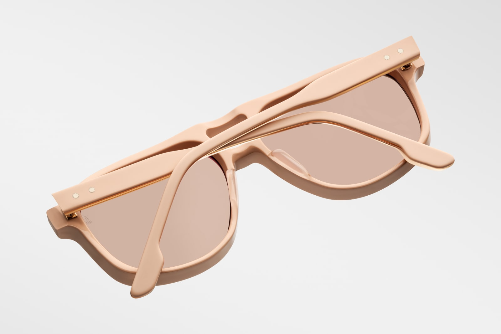 Bottom-up view of Jacques Marie Mage Leonard Suede sunglasses in Dust Suede: emphasizes the thickness of the acetate frame and the distinctive shape of the lenses. The light gold wirecore is visible along the inner edge of the temples.