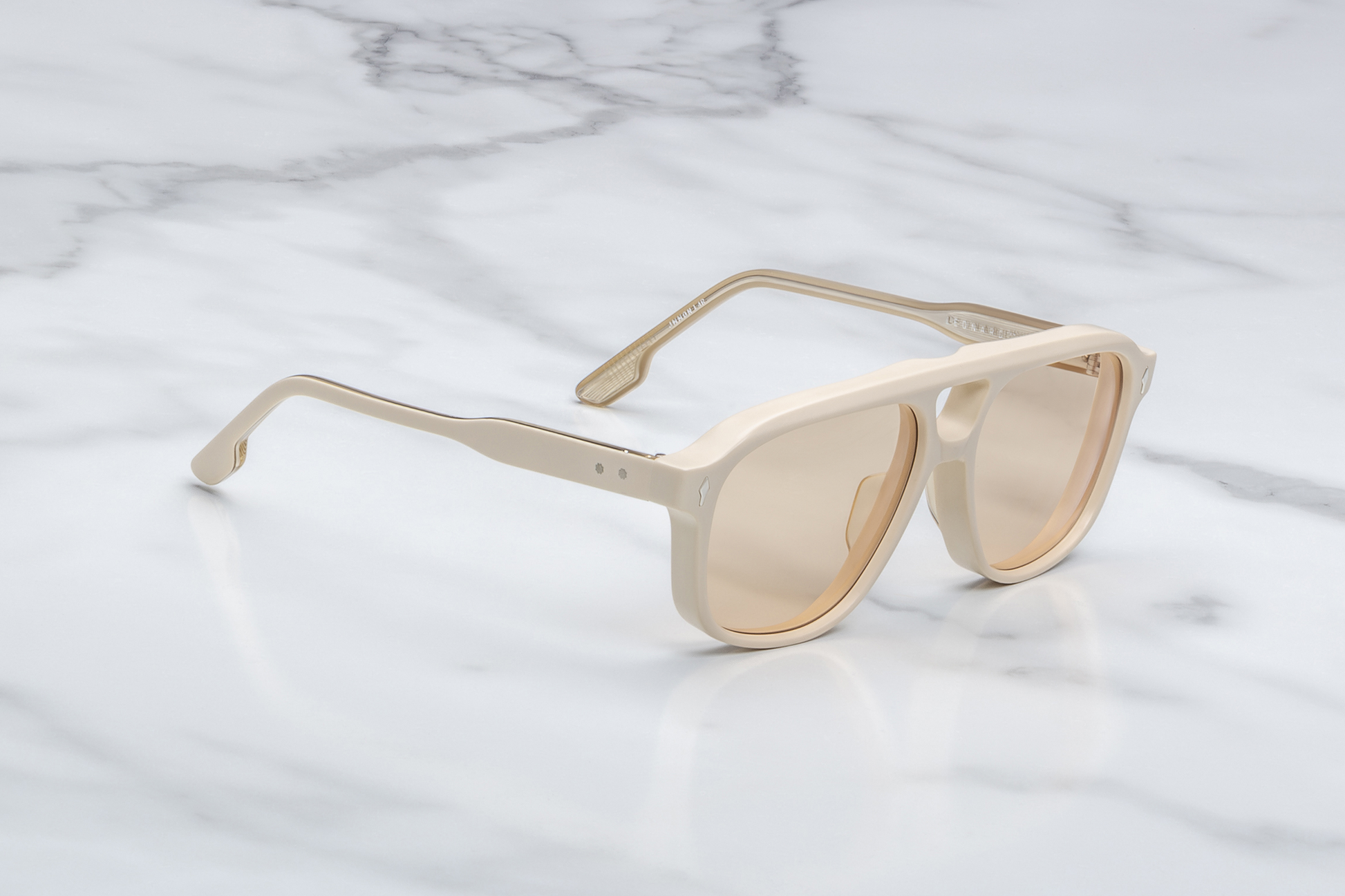 Side profile of Jacques Marie Mage Leonard Suede sunglasses in Sun Suede: showcases the thick acetate front transitioning into slim, sculpted temple arms. The temples are custom double-laminated acetate with light gold metal accents and Vauxhall wirecore exposed along the inner edge.