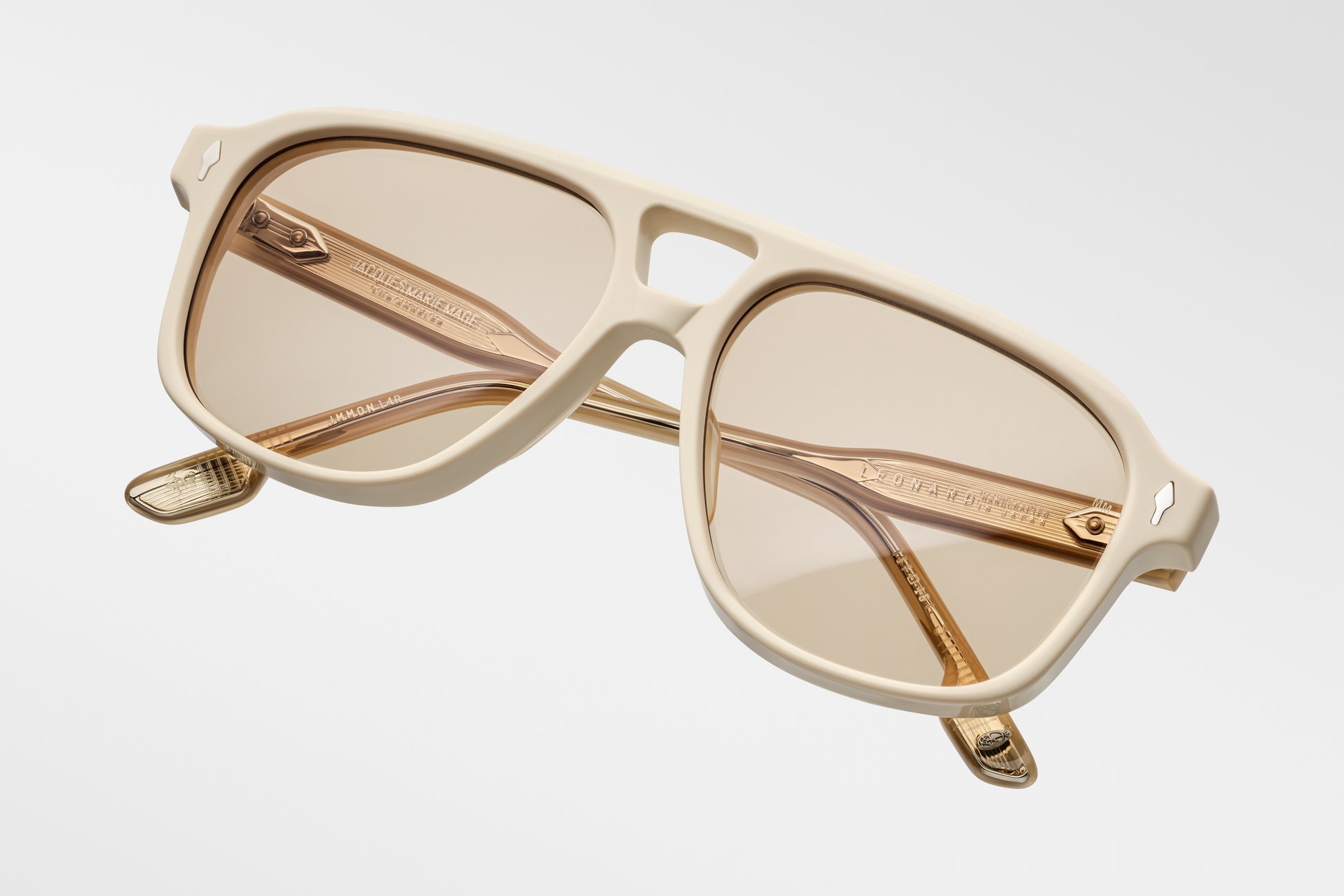 Top-down view of Jacques Marie Mage Leonard Suede sunglasses in Sun Suede: reveals the smooth, tactile matte exterior of the acetate frame and the curvature of the lenses. The double-bridge design is visible, showcasing the frame's structure.