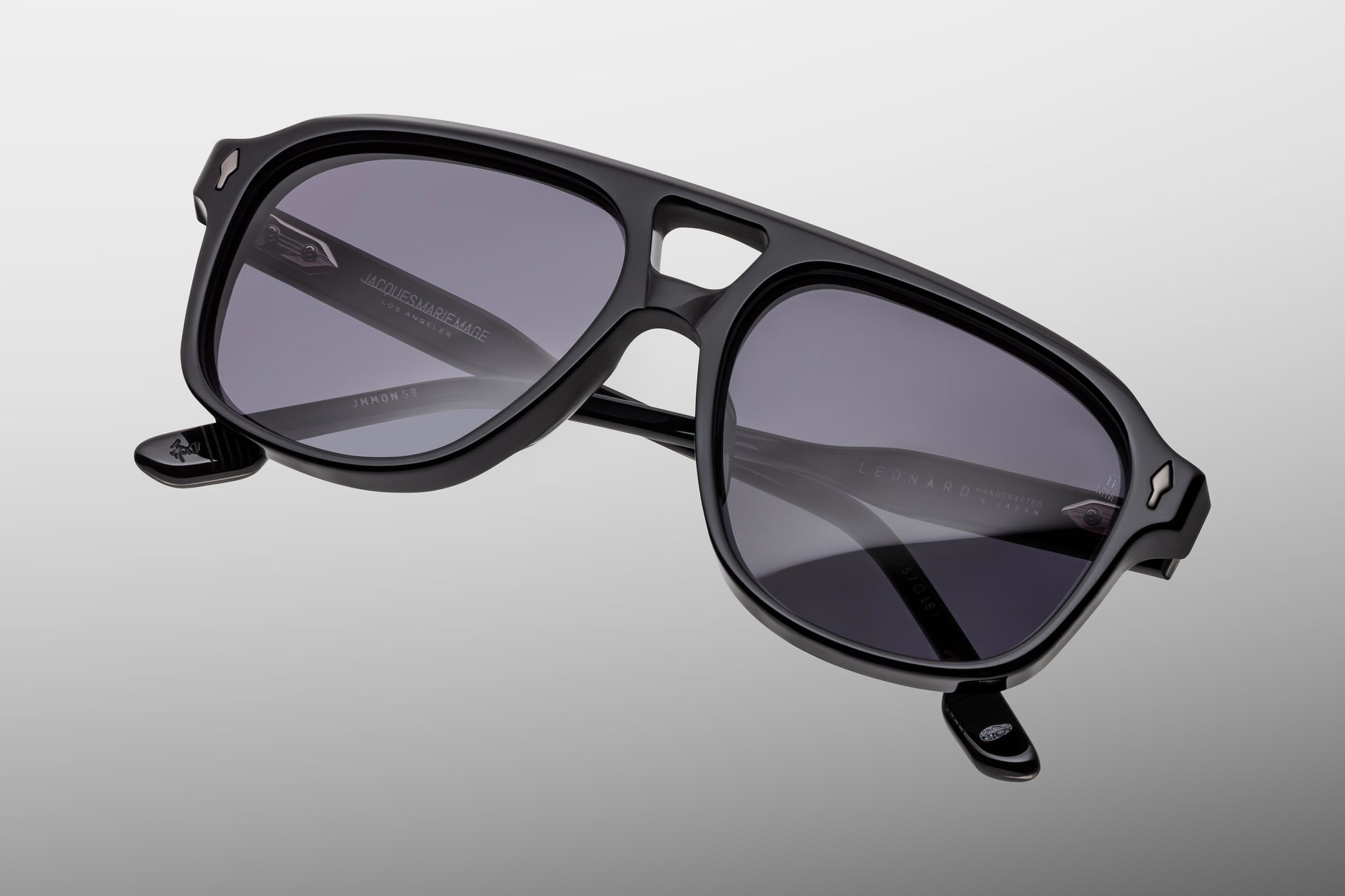 Close-up front view of Jacques Marie Mage Leonard Raven sunglasses featuring a refined navigator shape, double bridge and grey gradient CR39 lenses