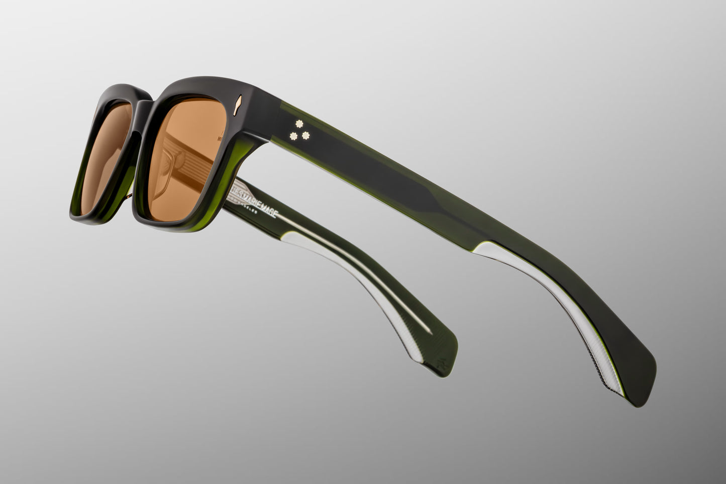 Close-up front detail of Jacques Marie Mage Molino Borneo frame showing silver arrowhead rivets, polished green acetate and lens tint
Macro front view of JMM Molino Borneo sunglasses highlighting rectangular lens shape and handcrafted bevelled edges