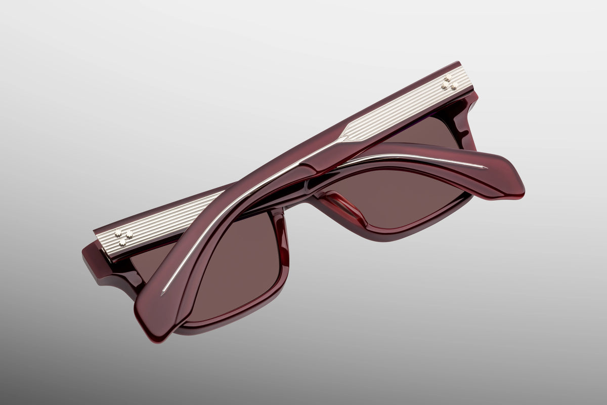 Inner rear view of Jacques Marie Mage Molino Bordeaux Empire sunglasses, showcasing the heavy-duty 7-barrel hinge with spur-shaped rivets and the limited-production batch number foil-stamped in gold text on the interior temple arm.