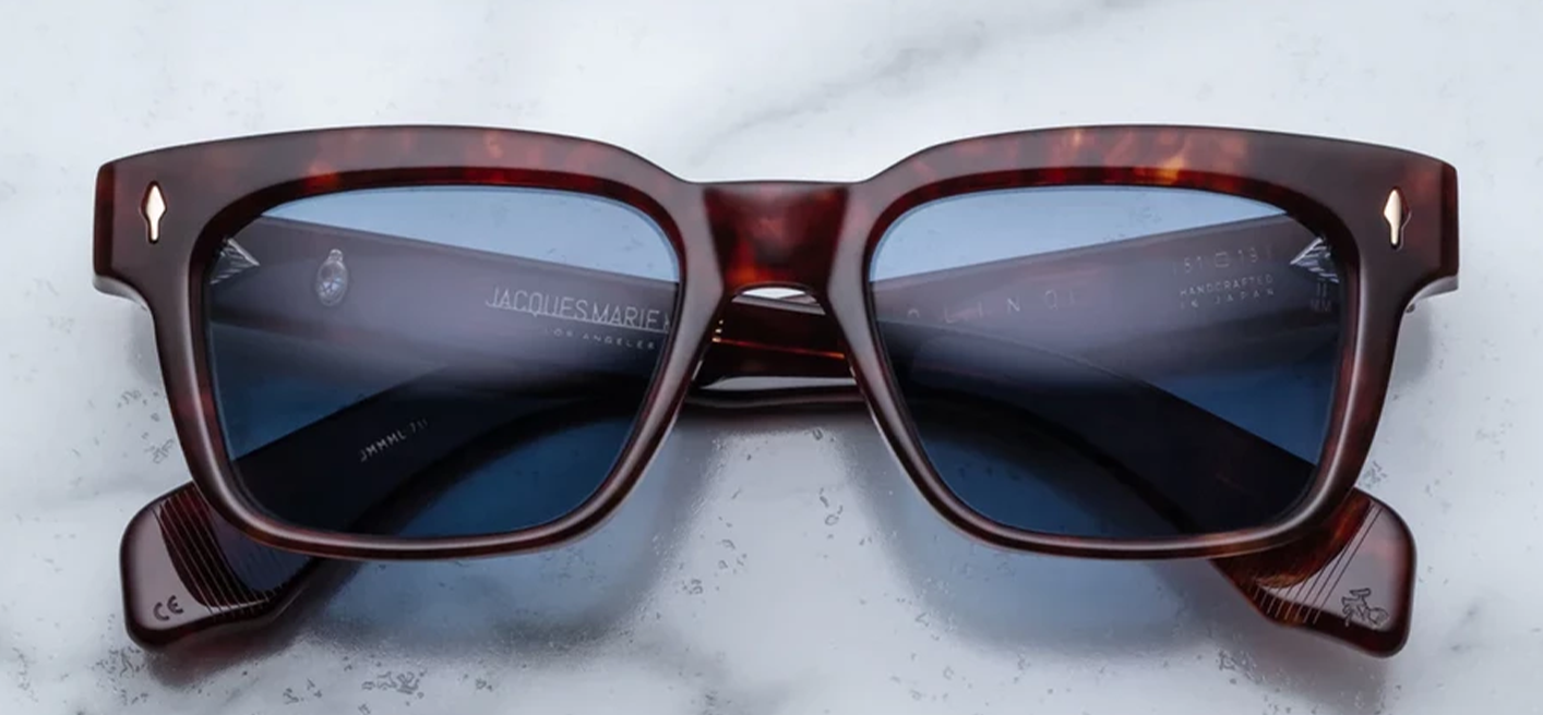 Front view of Jacques Marie Mage Molino 51 sunglasses in Breccia Havana tortoise shell acetate, showcasing a bold rectangular 1960s-inspired frame with Prussian Blue lenses and light gold arrowhead pins