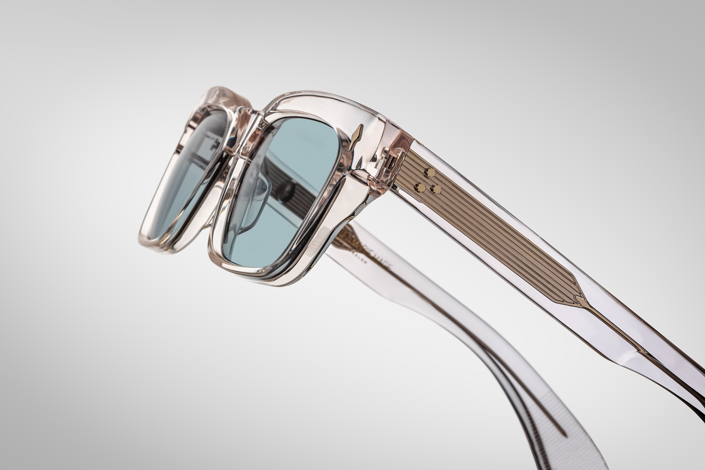 Left temple of the Molino Cameo — double-laminated cameo acetate arm revealing exposed light‑gold wire‑core and a gold tension-secured 7-barrel hinge