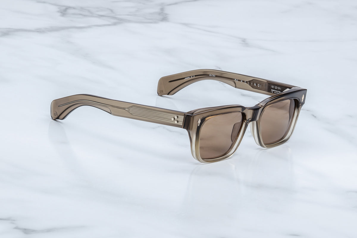 Three-quarter view of the Jacques Marie Mage Molino Lescot sunglasses. This angle showcases the frame's heavy volume and subtle brow line beveling, transitioning into dual-layered temples that reveal a silver filigree wire core beneath translucent clear acetate.
