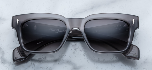 Front of the Molino 51 Prime — a blocky, rectangular 1960s-inspired frame in grey 10 mm cured cellulose acetate, with a subtle bevel and sterling silver arrowhead front pin