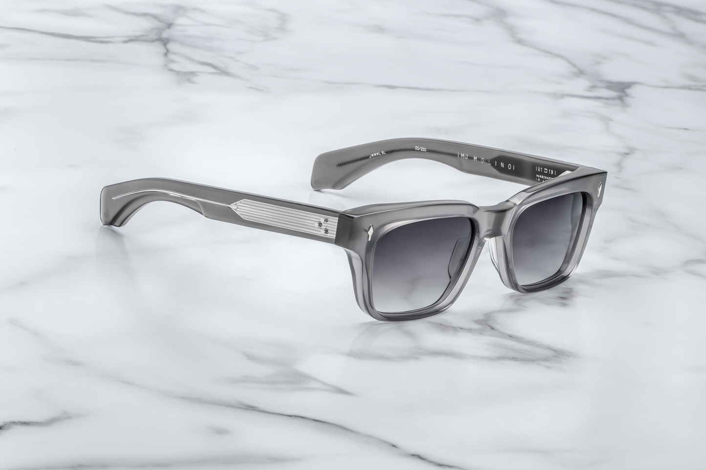 Right temple of the Molino 51 Prime — double-laminated grey acetate with exposed sterling silver wire-core and a custom 7‑barrel hinge.