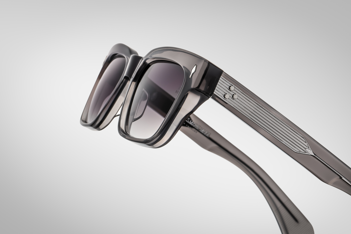 Left side of Molino 51 Prime — grey acetate arm displaying the engraved silver wire-core, the tension-secured hinge, and tapering temple tip