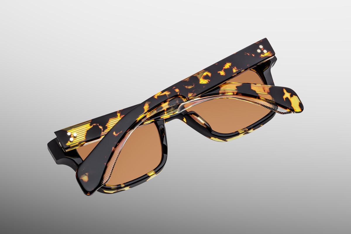 Inner rear view of Jacques Marie Mage Molino Tokyo sunglasses, detailing the heavy-duty 5-barrel hinge with spur-shaped rivets and the limited-production batch number foil-stamped in silver text on the inner temple arm.