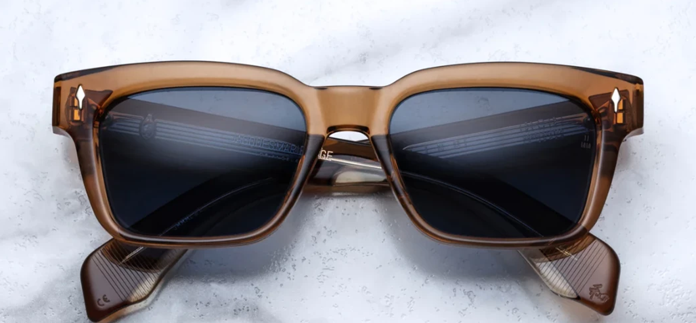Front view of Jacques Marie Mage Molino 51 sunglasses in Whiskey translucent amber-brown acetate, displaying a bold rectangular 1960s shape with gradient grey lenses and sterling silver arrowhead front pins