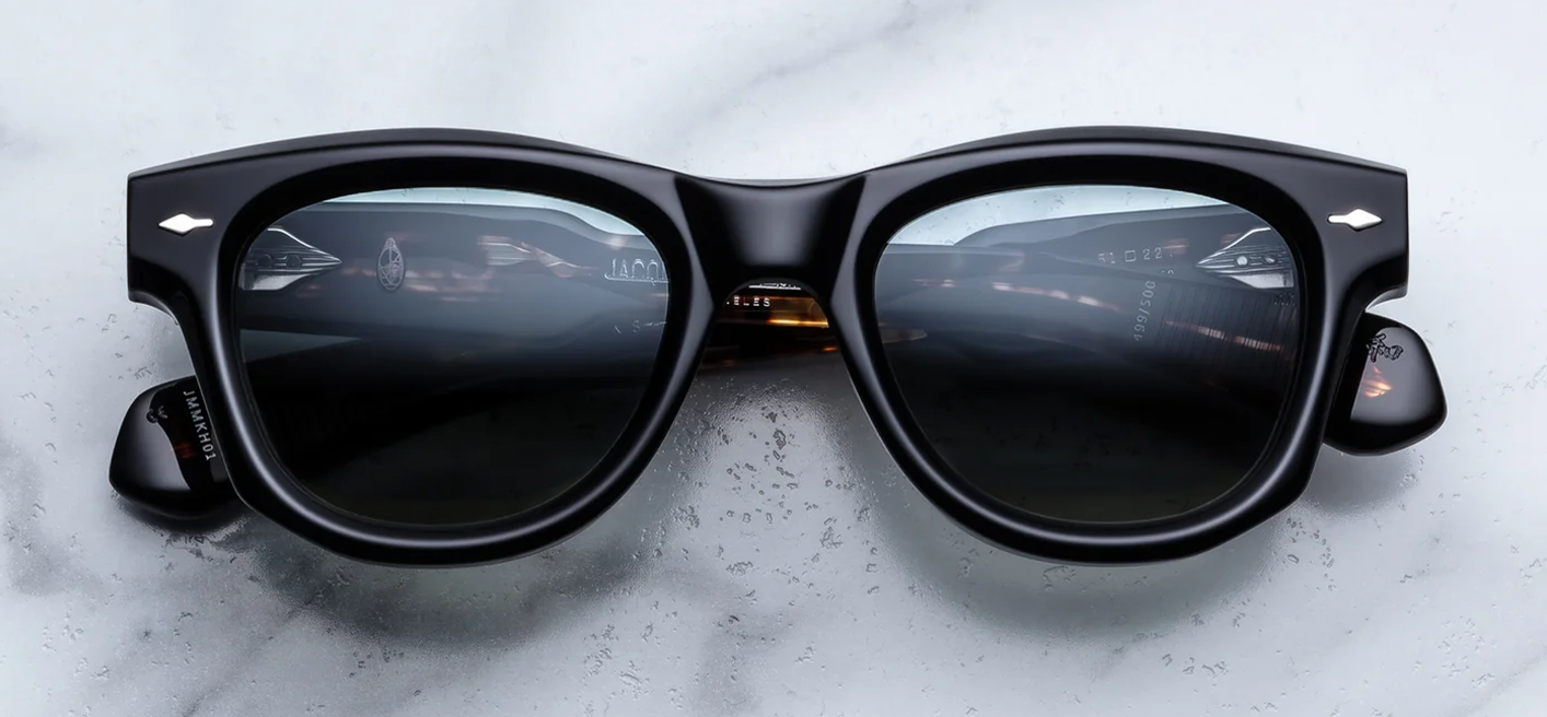  Front view of Jacques Marie Mage Kinshasa sunglasses in high-gloss polished Noir black acetate with round lenses, featuring signature sterling silver arrowhead pins on the frame corners