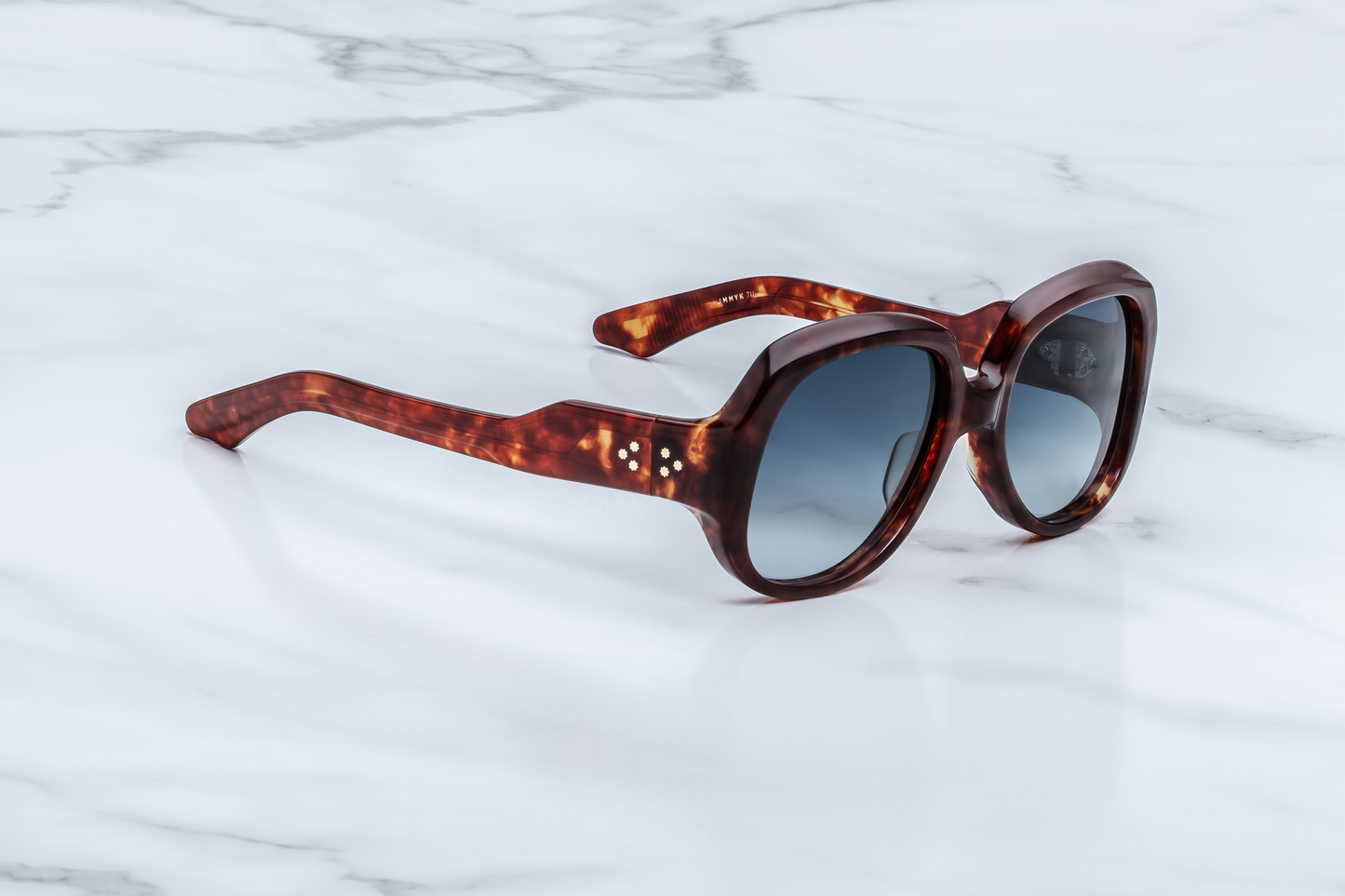 Side profile of Ocean Child Breccia — double-laminated breccia acetate temples revealing exposed hairline-engraved art-deco wire-core and light-gold 7‑barrel hinge