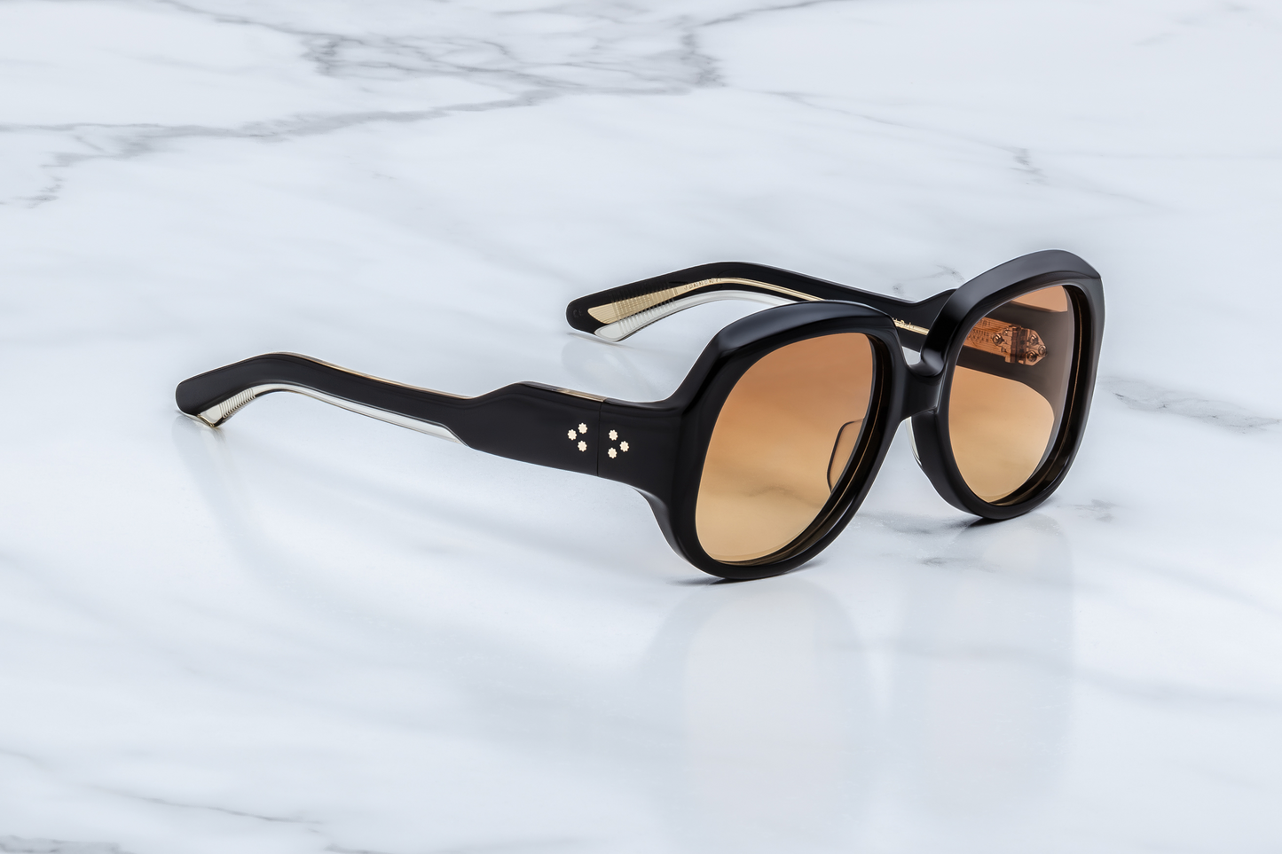 Side profile of Ocean Child Beluga — thick double-laminated beluga acetate temples with exposed art‑deco engraved wire-core and dark-gold 7‑barrel hinge