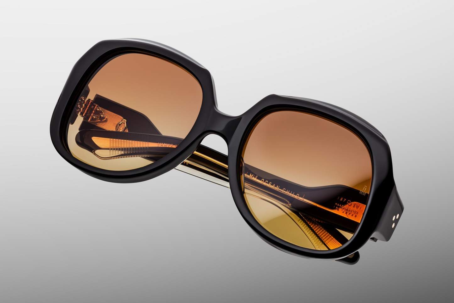 Top-down view of Ocean Child Beluga — wide 20 mm keyhole bridge, softly curved browline, and smooth bevelled edges in black‑midnight acetate