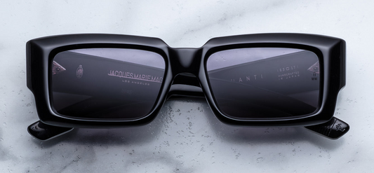 Jacques Marie Mage Quant sunglasses in Shadow front view – bold black acetate square frame with dark lenses and signature arrowhead rivets – available at Wink Optometrists