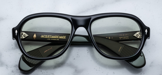 Jacques Marie Mage Richard Cobra sunglasses, showcasing a modern aviator silhouette with a flat browline and wide temples. The frame is crafted from 10mm black cured cellulose acetate, featuring sterling silver arrowhead front pins and exposed wirecore details. The light bottle green CR39 lenses offer 100% UV protection and backside anti-reflective treatment.