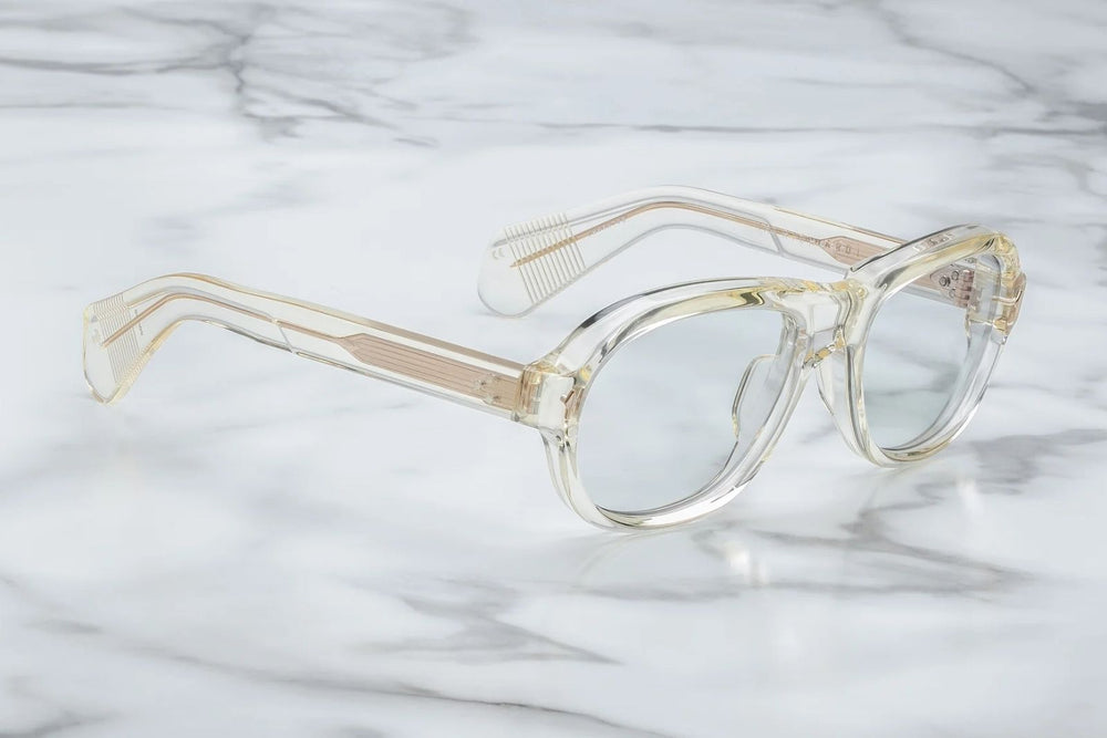 Side profile of Jacques Marie Mage Richard sunglasses in Brut: showcases the thick acetate front transitioning into slim, sculpted temple arms. The temples are custom double-laminated acetate with light gold metal accents and Vauxhall wirecore exposed along the inner edge.