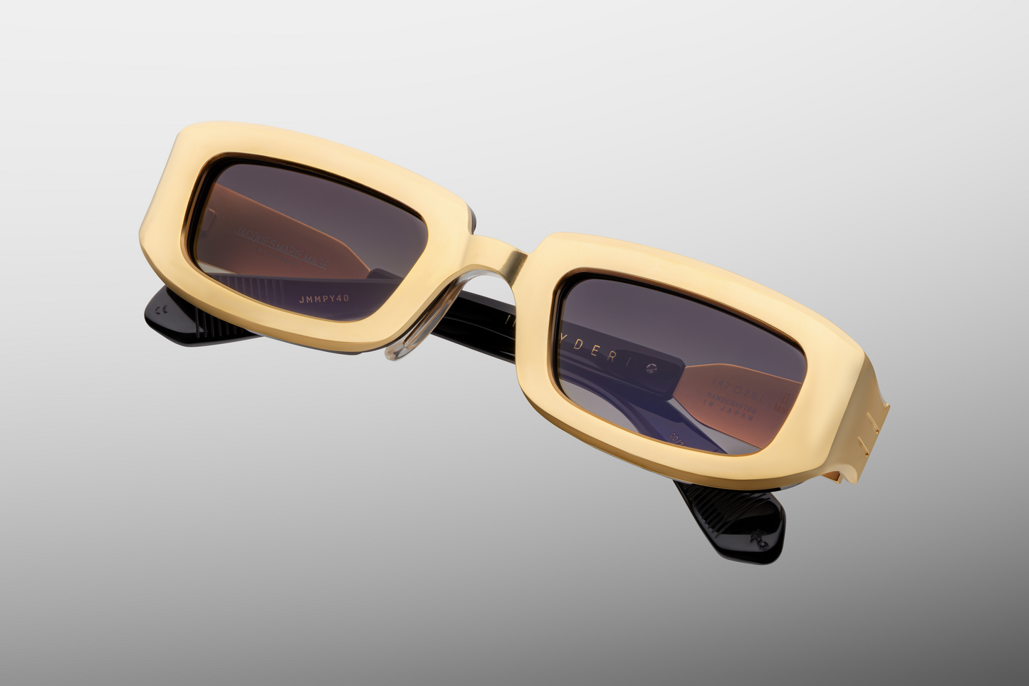 Close up front detail of Jacques Marie Mage Ryder sunglasses in Gold showing refined titanium construction, sculpted bridge and premium tinted lenses – available at Wink Optometrists
