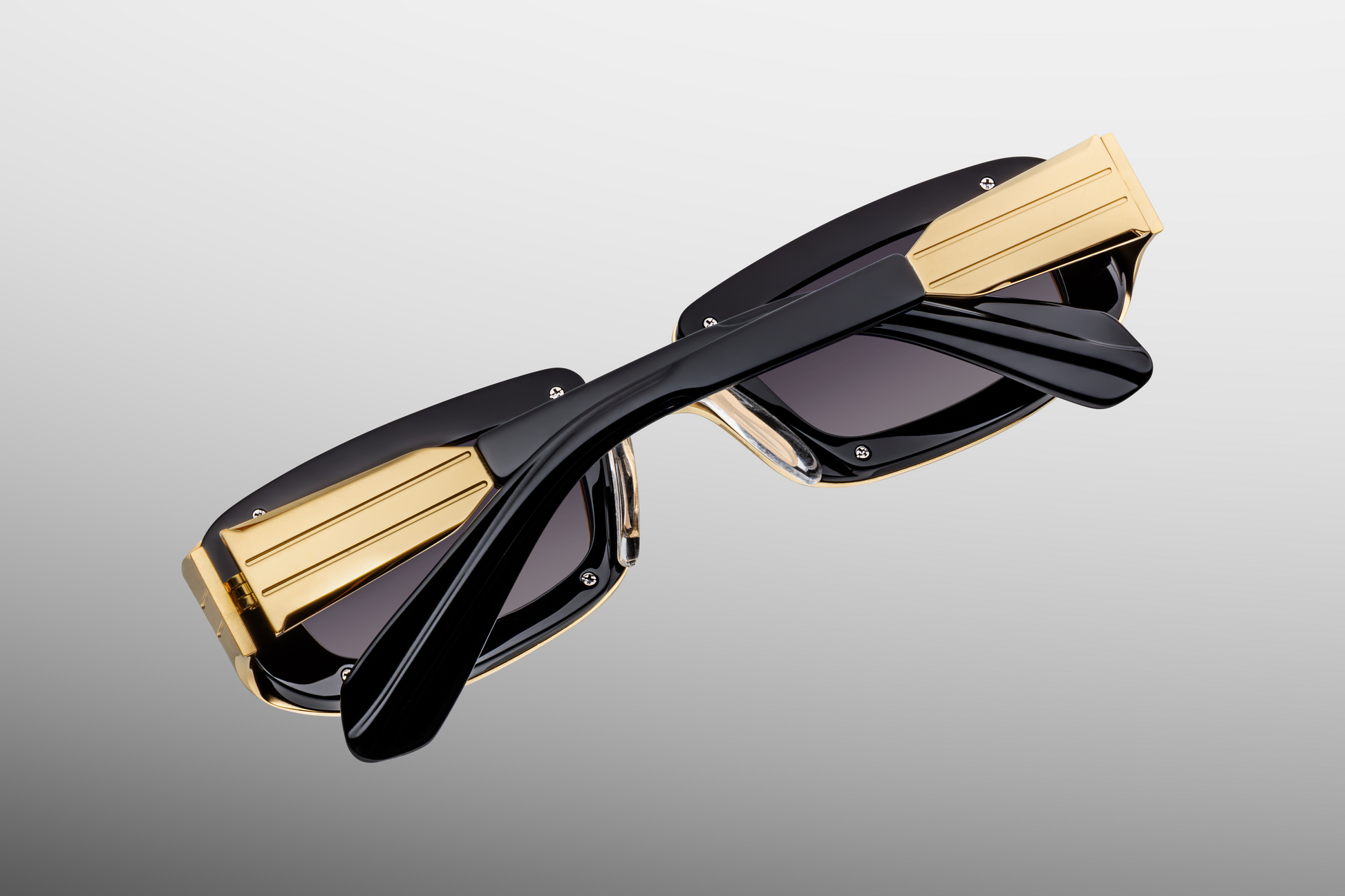 Close up back detail of Jacques Marie Mage Ryder Gold sunglasses highlighting titanium frame craftsmanship and premium hinge construction – available at Wink Optometrists