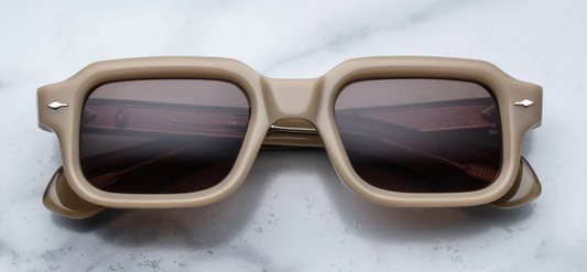 The Sandro Chateau sunglasses feature a bold, '90s-inspired rectangular silhouette crafted from 10mm thick Japanese cellulose acetate. The frame's substantial width and sharp angles exude a commanding presence. Silver arrowhead front pins at the temples add a touch of signature detailing. The lenses are brown CR39 with a 4-base curve, offering 100% UV protection and a subtle anti-reflective coating on the back