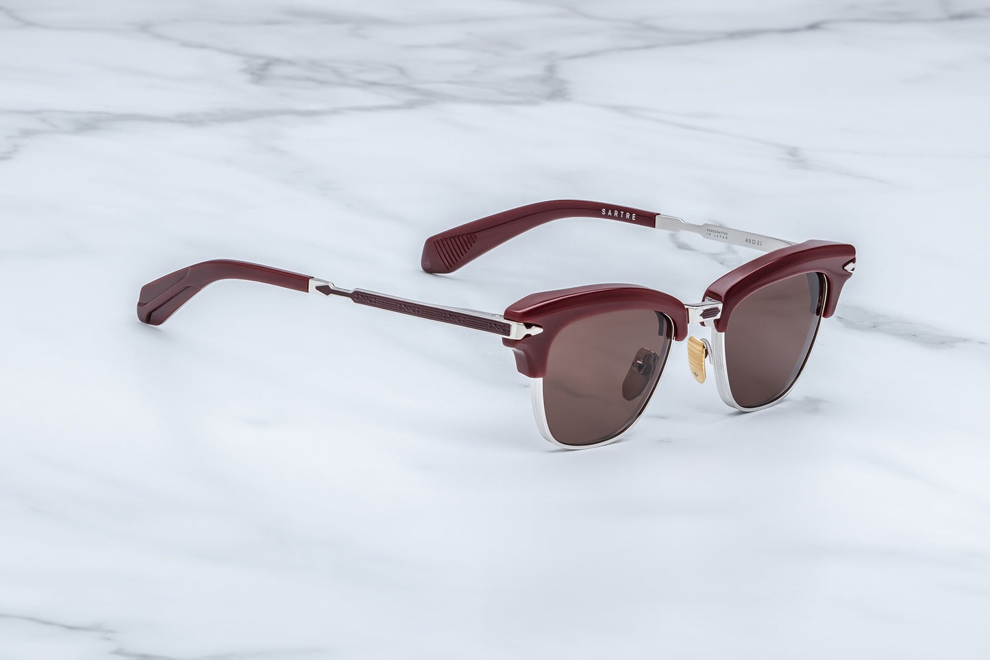 Jacques Marie Mage Sartre Bordeaux sunglasses side profile showing engraved titanium temples, deep red acetate brow bar, and premium hinge detailing