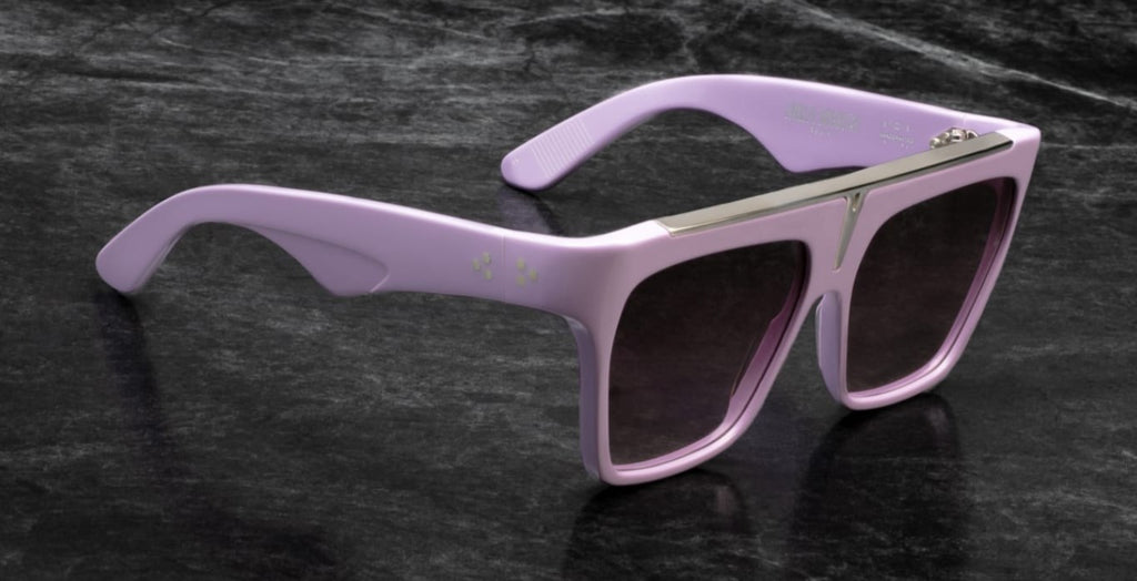 Three-quarter view of Selini lavender — bold 7 mm purple acetate frame with silver top-bar insert and exaggerated browline