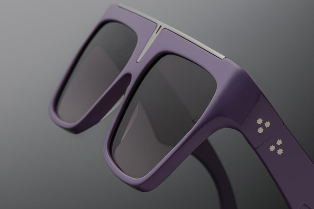 Side profile of JMM Selini lavender — lilac double-laminated temples, silver tension-secured 7-barrel hinge, and hidden wire core