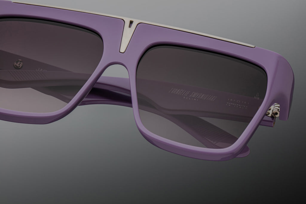Close-up of JMM Selini lavender — soft purple acetate with a silver top-bar insert and wine-gradient CR39 lens.