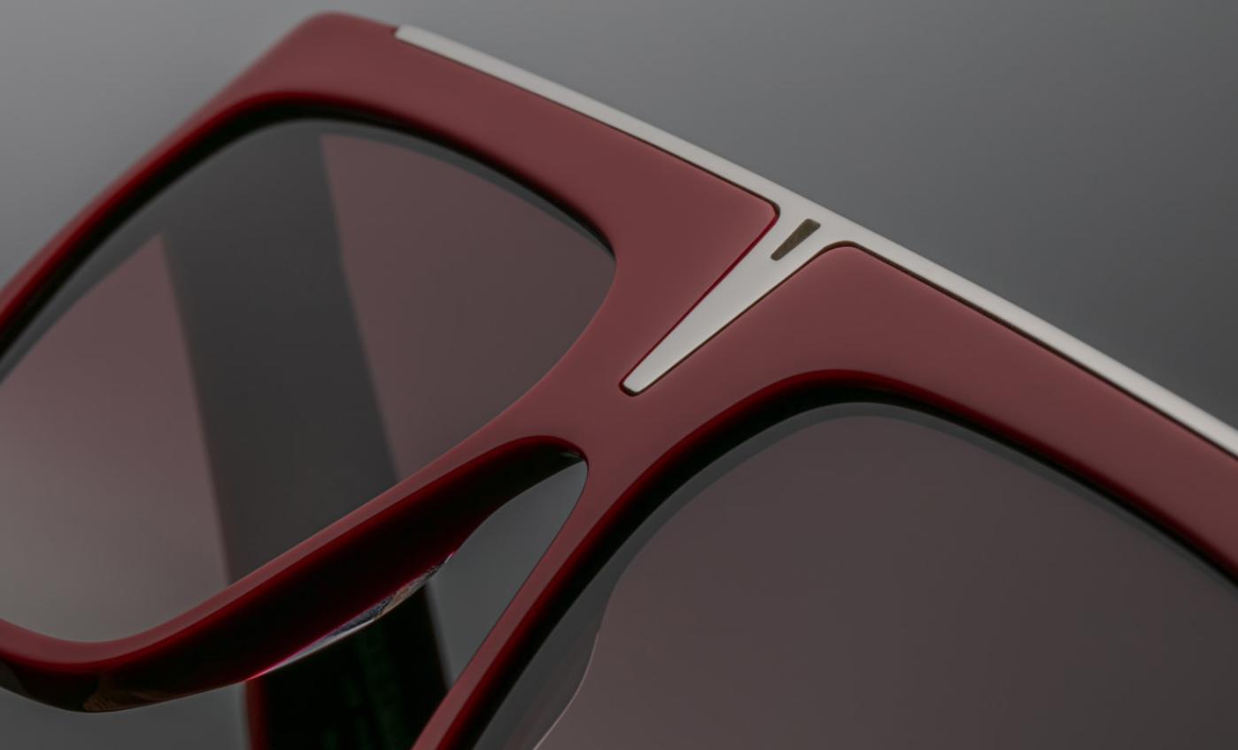 Top-down view of Selini Ruby — straight single brow bar, flat-top design, and smooth bevelled edges of the red acetate